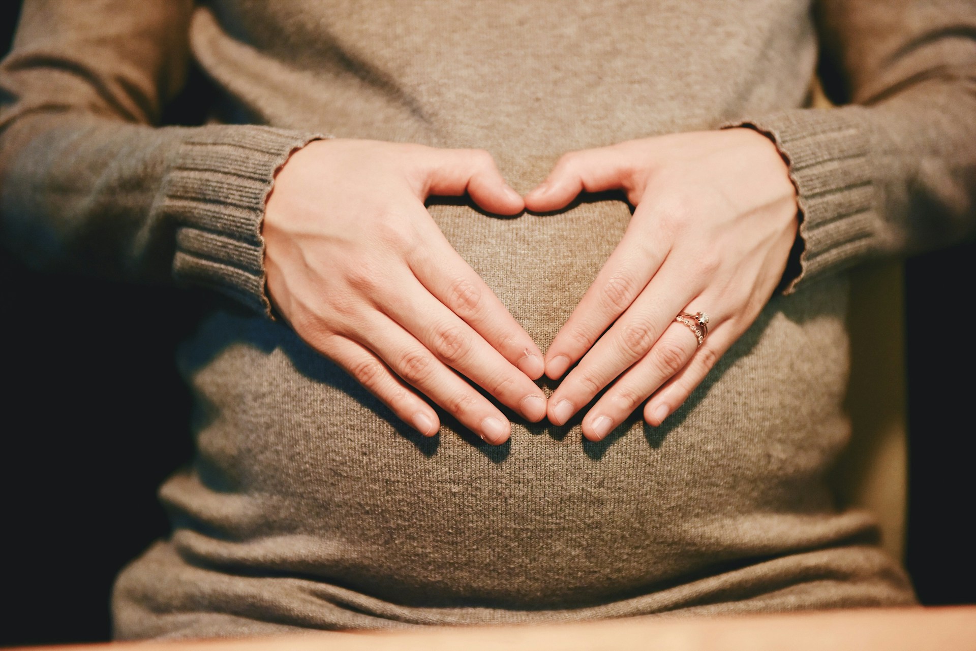 Heart Hands Over Pregnant Belly