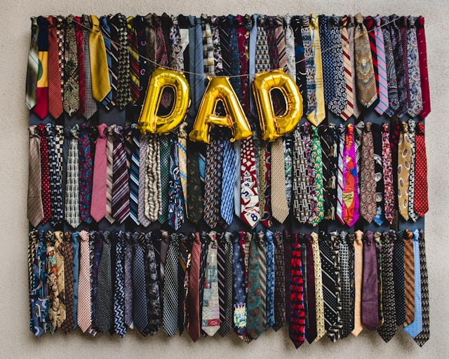 A "Dad" sign with ties in the background