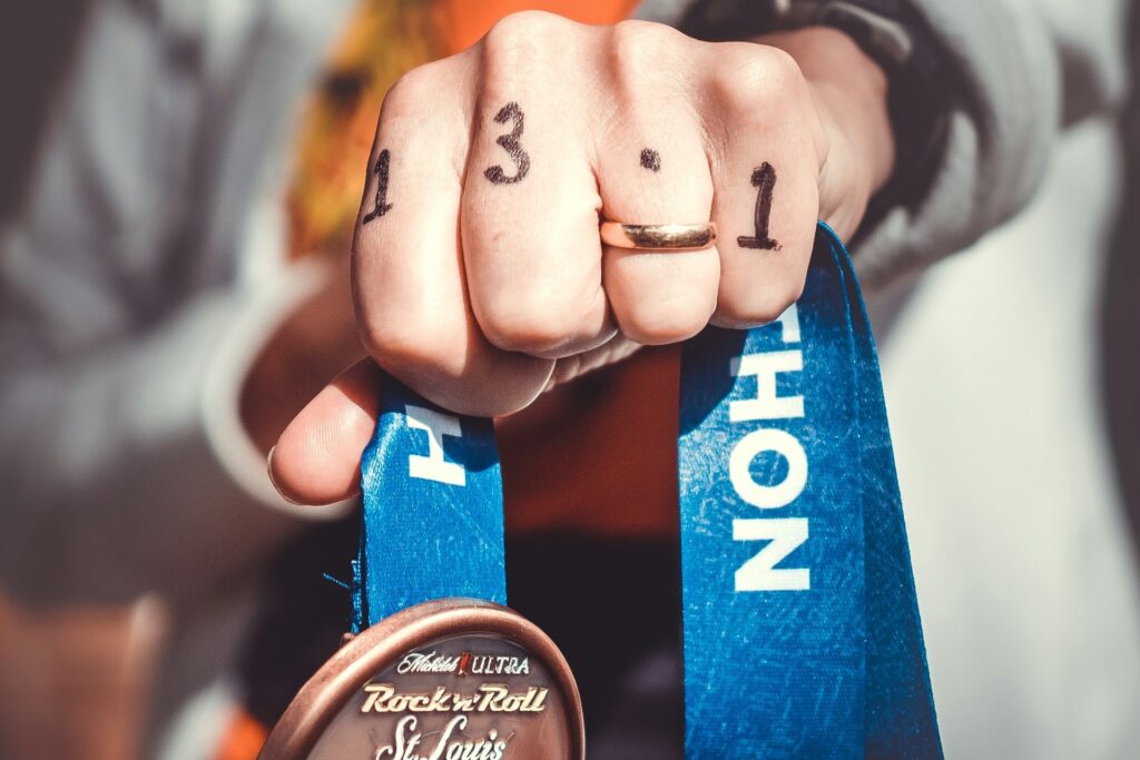 Runner Holding Medal for Half Marathon