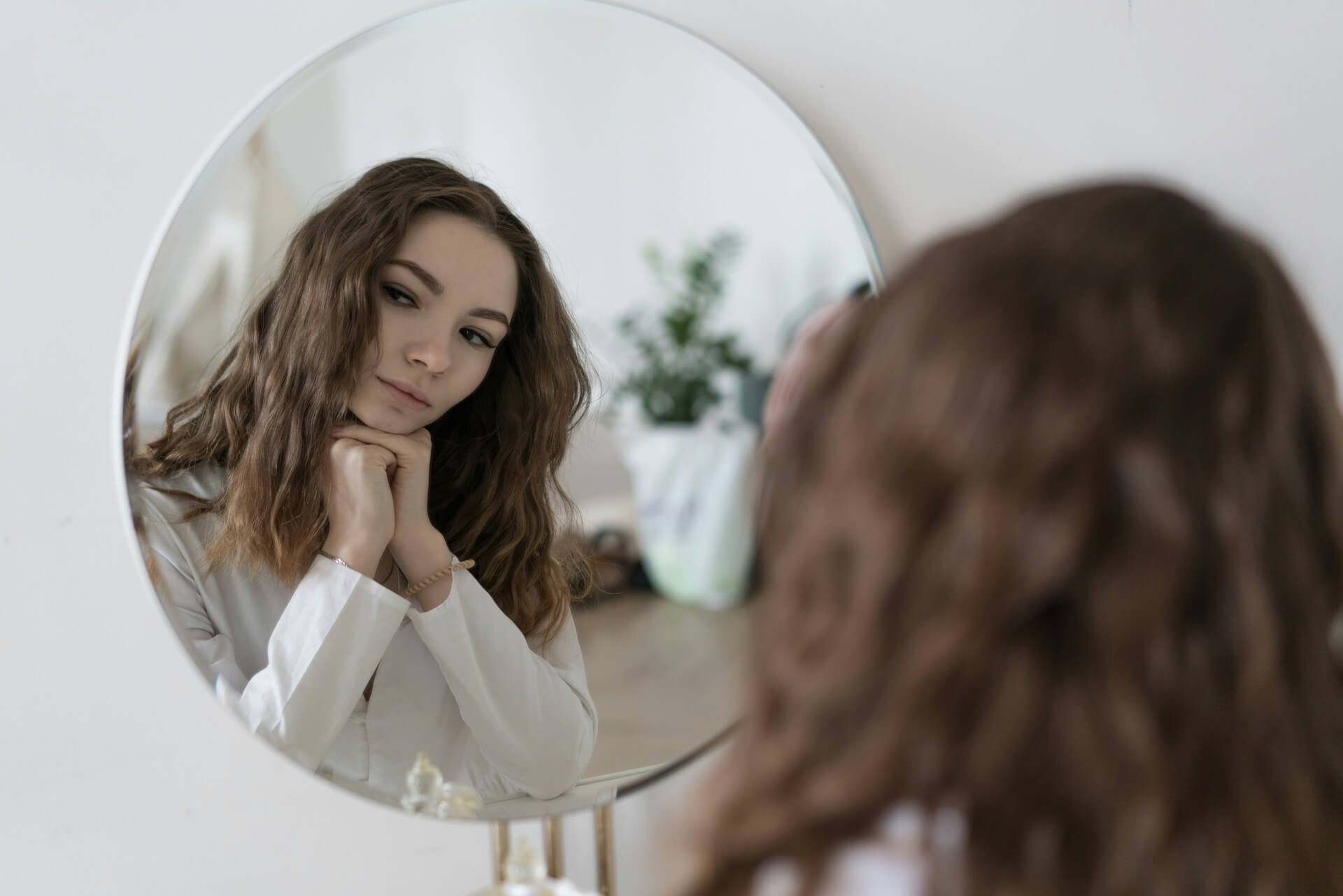 girl staring at mirror