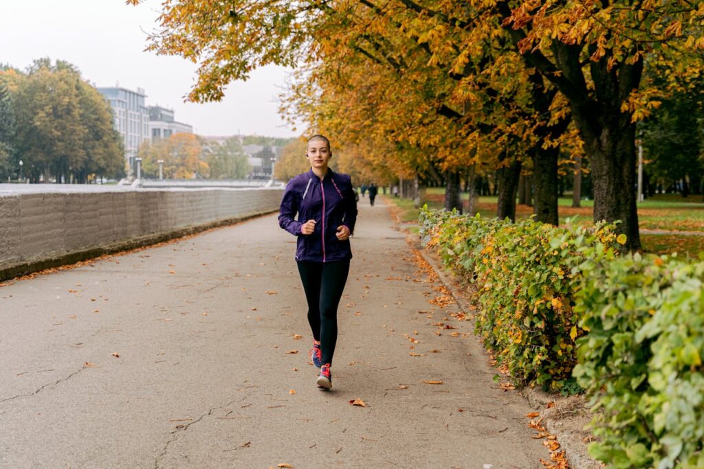 A woman jogging in fall workout gear