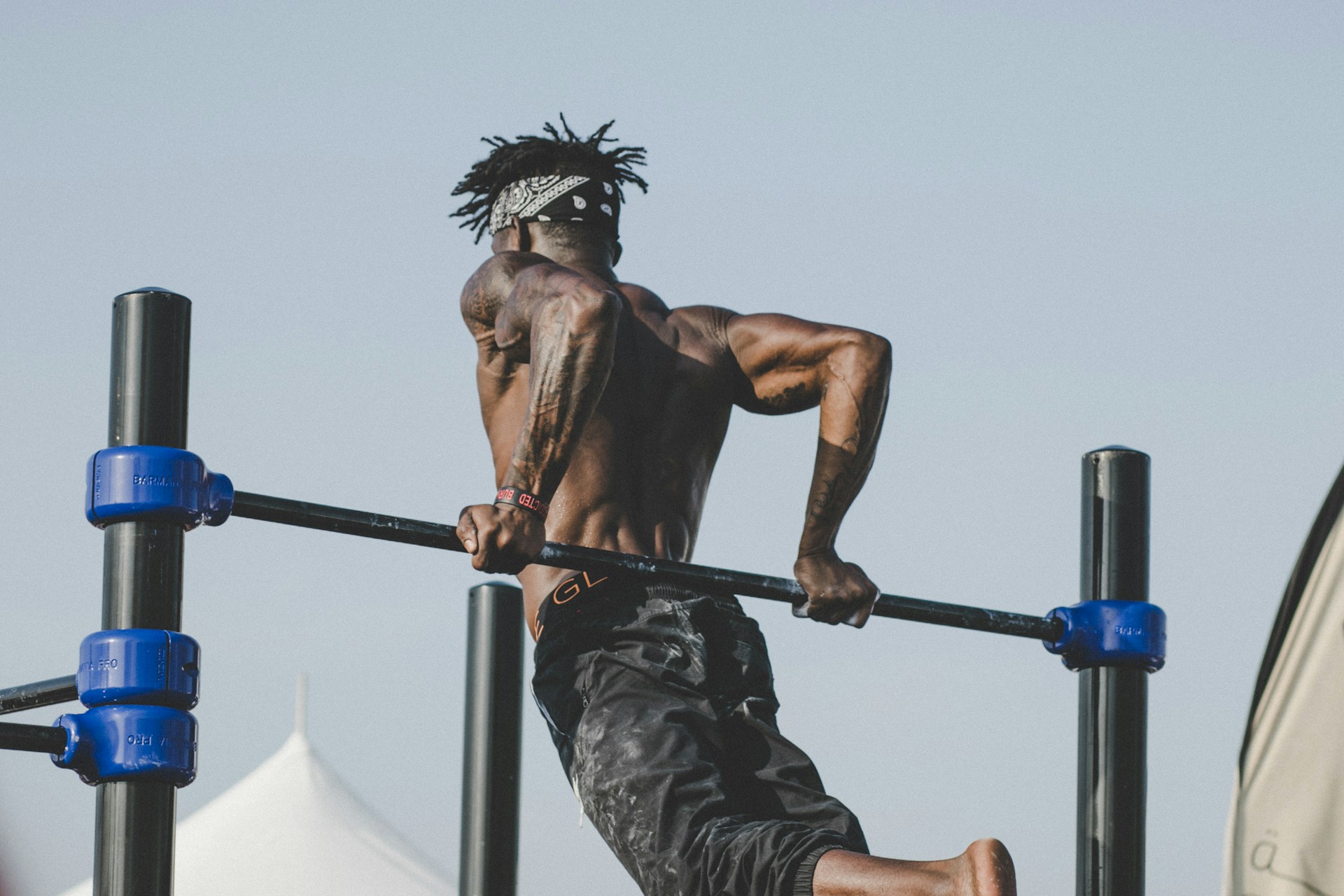 A man who is bulking working out at the gym.