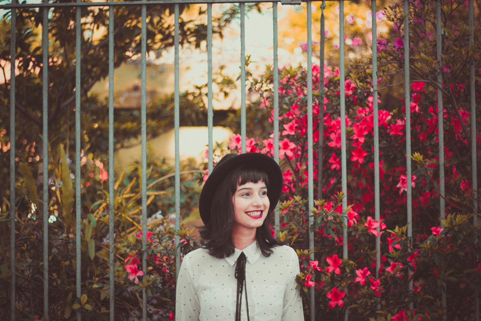 smiling in front of flowers