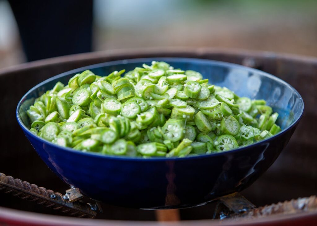 Freshly sliced okra in a blue bowl 