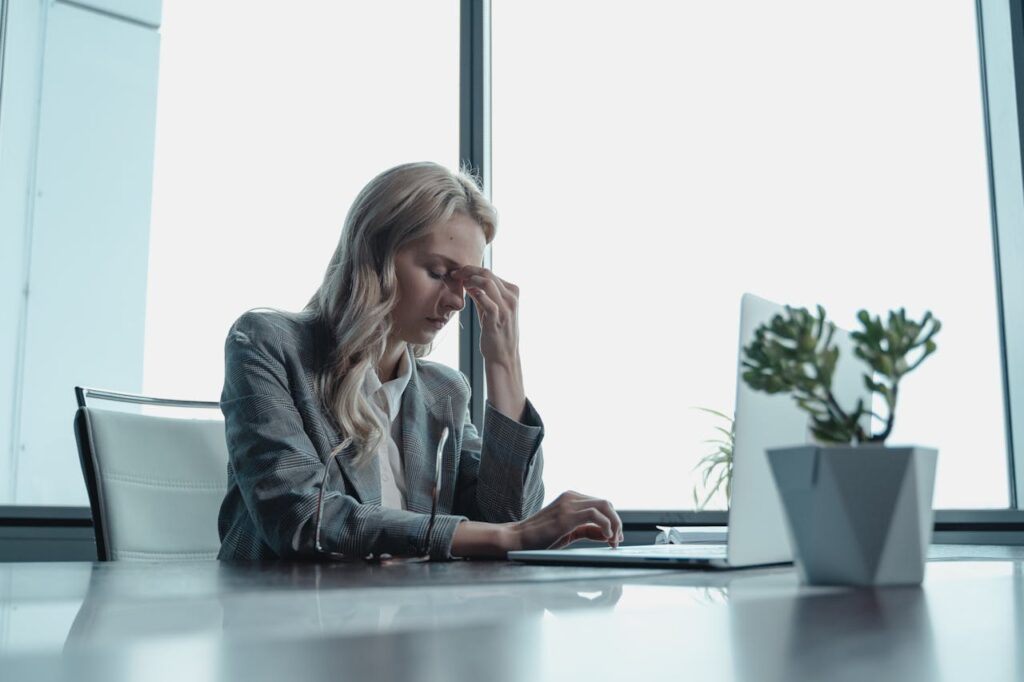 A stressed woman sitting in front of a laptop