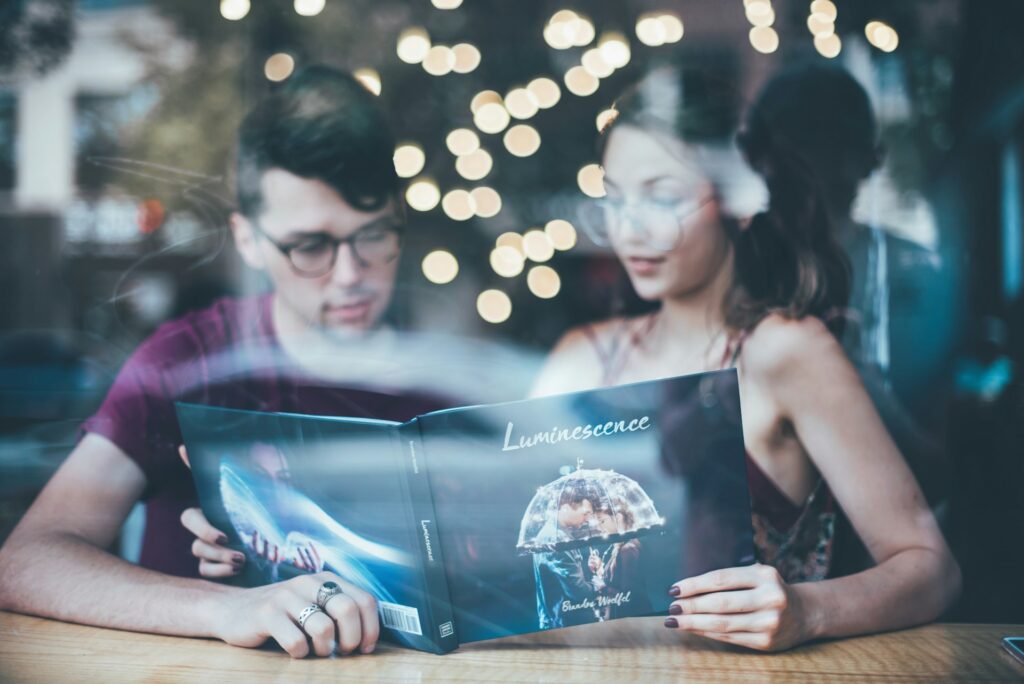 Man and Woman Reading a Book at a Table