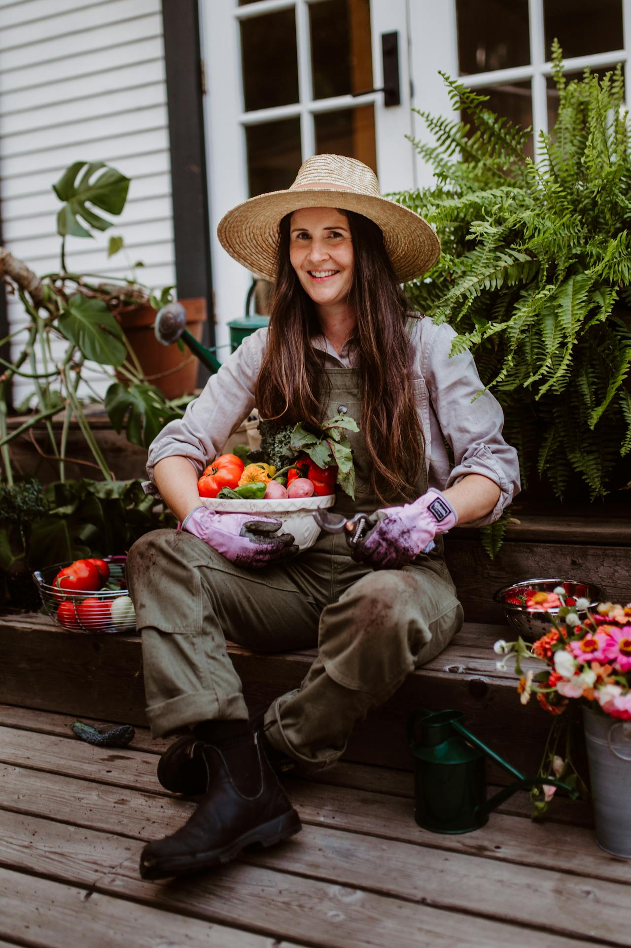 A gardener holding fresh vegetables