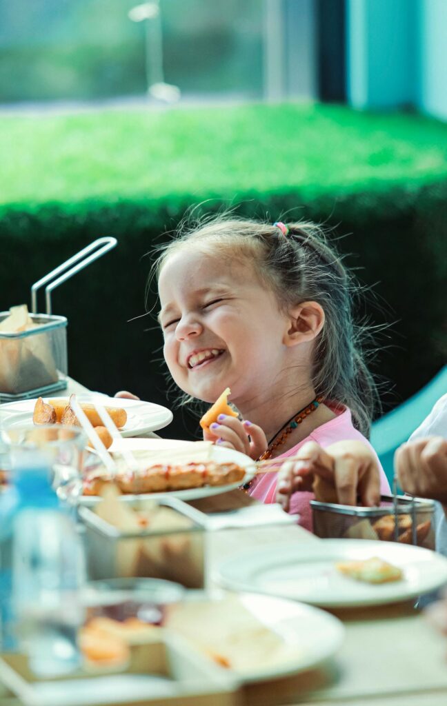 A little girl eating at a party 