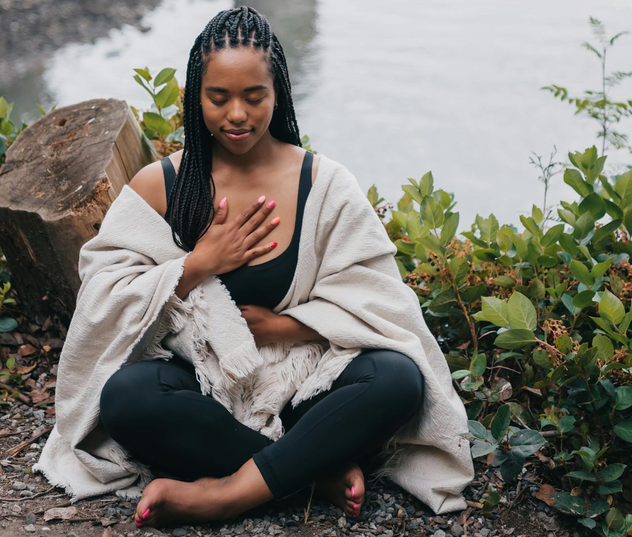 A woman breathing by a lake