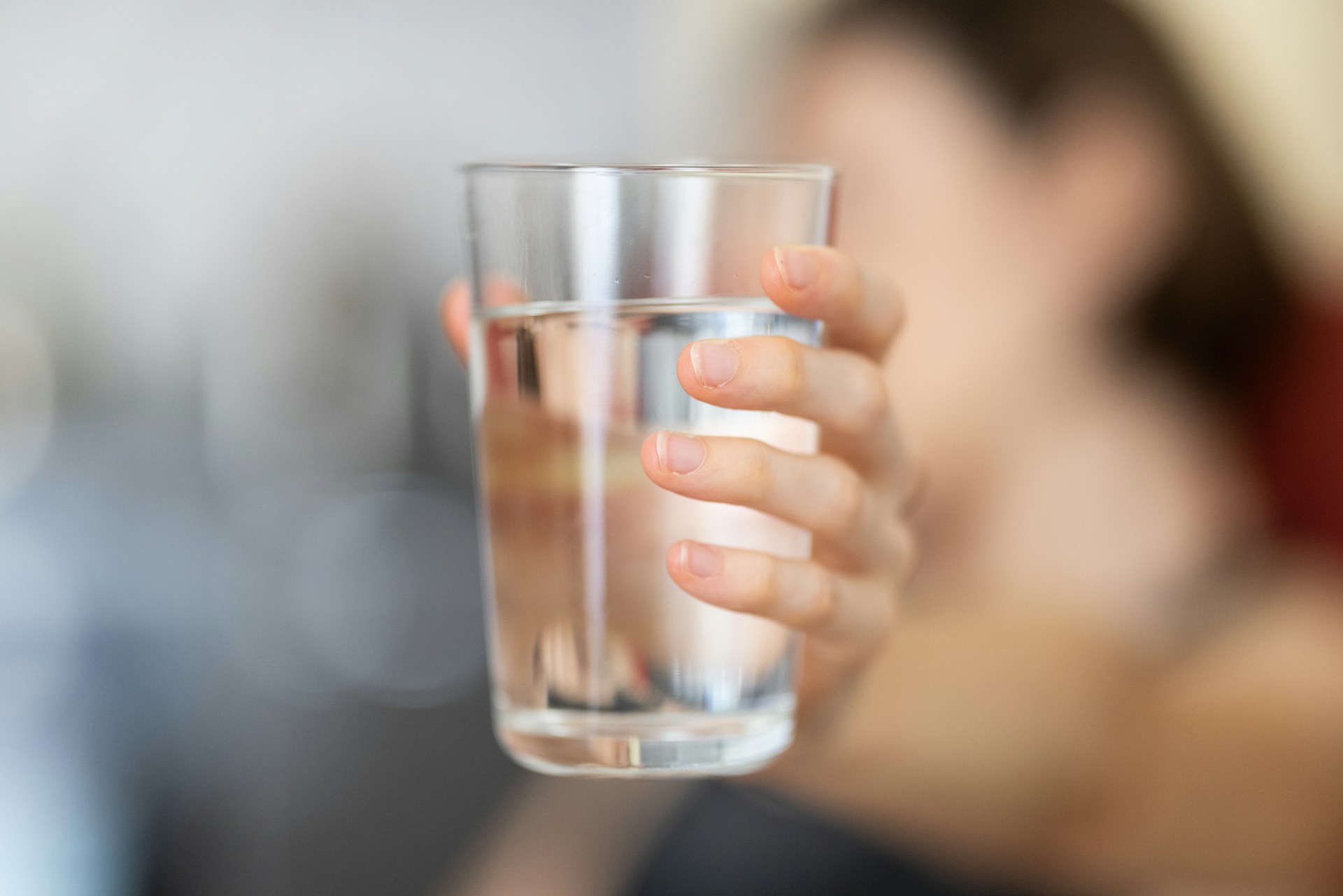 Someone holding a glass of water.