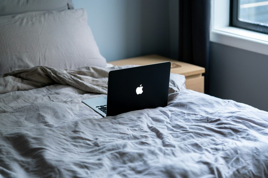 A laptop on a bed.