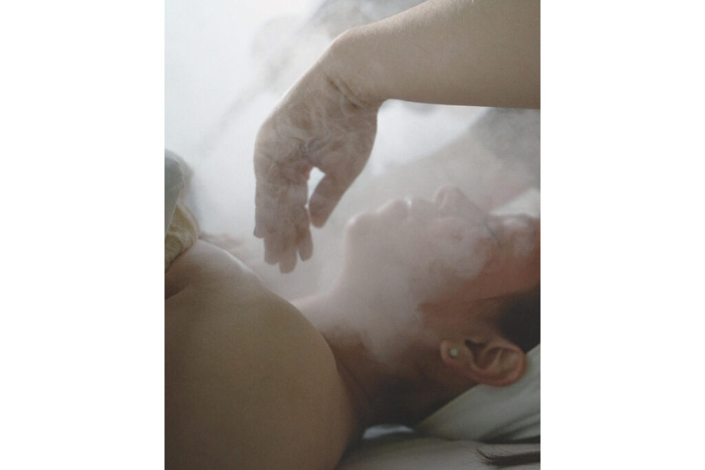 A person receiving a steam facial