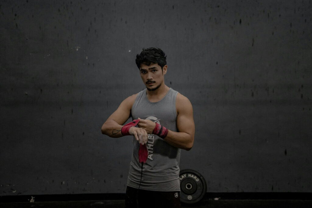 A man strapping his wrists before working out