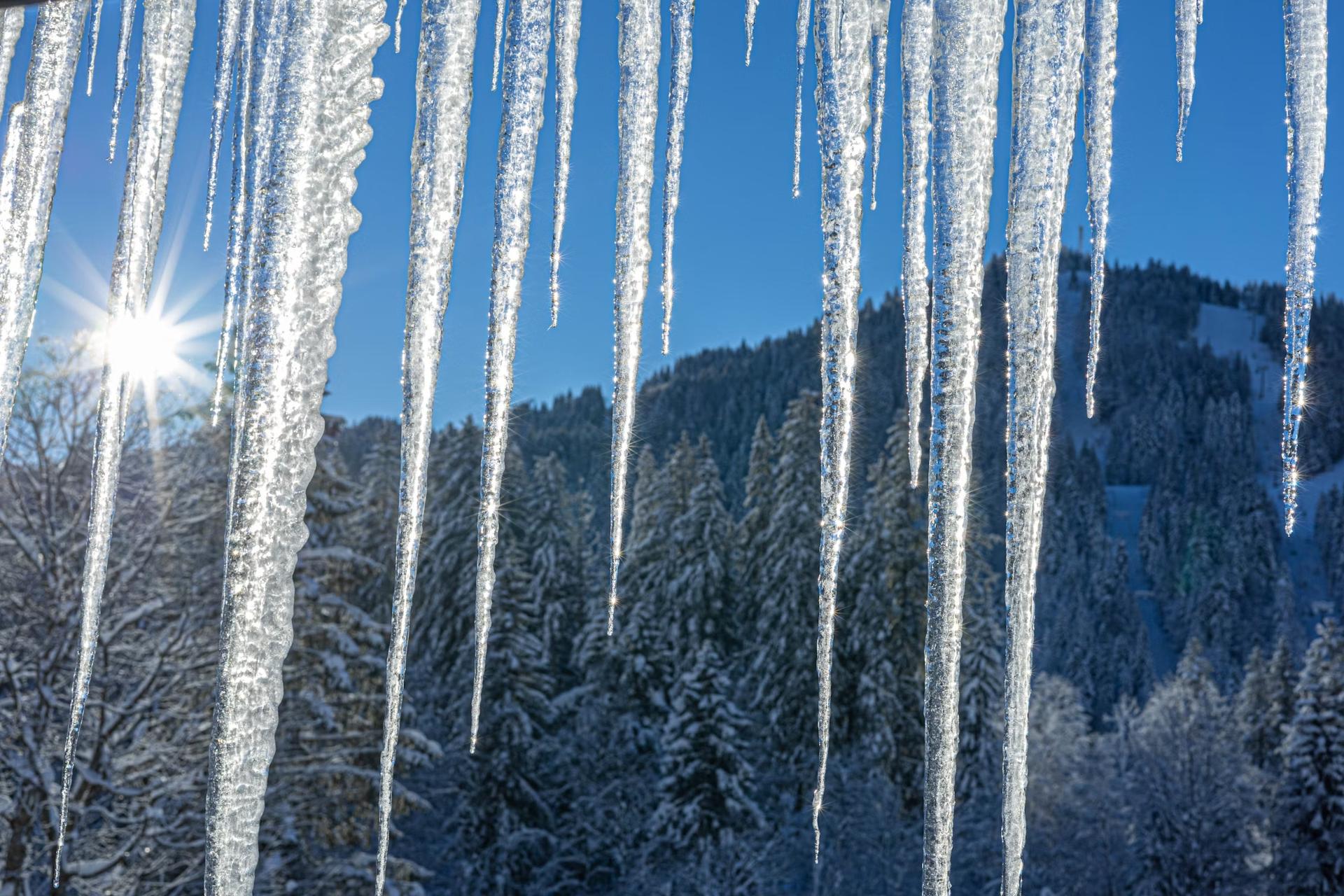 icicles hanging down from roof in sunslight