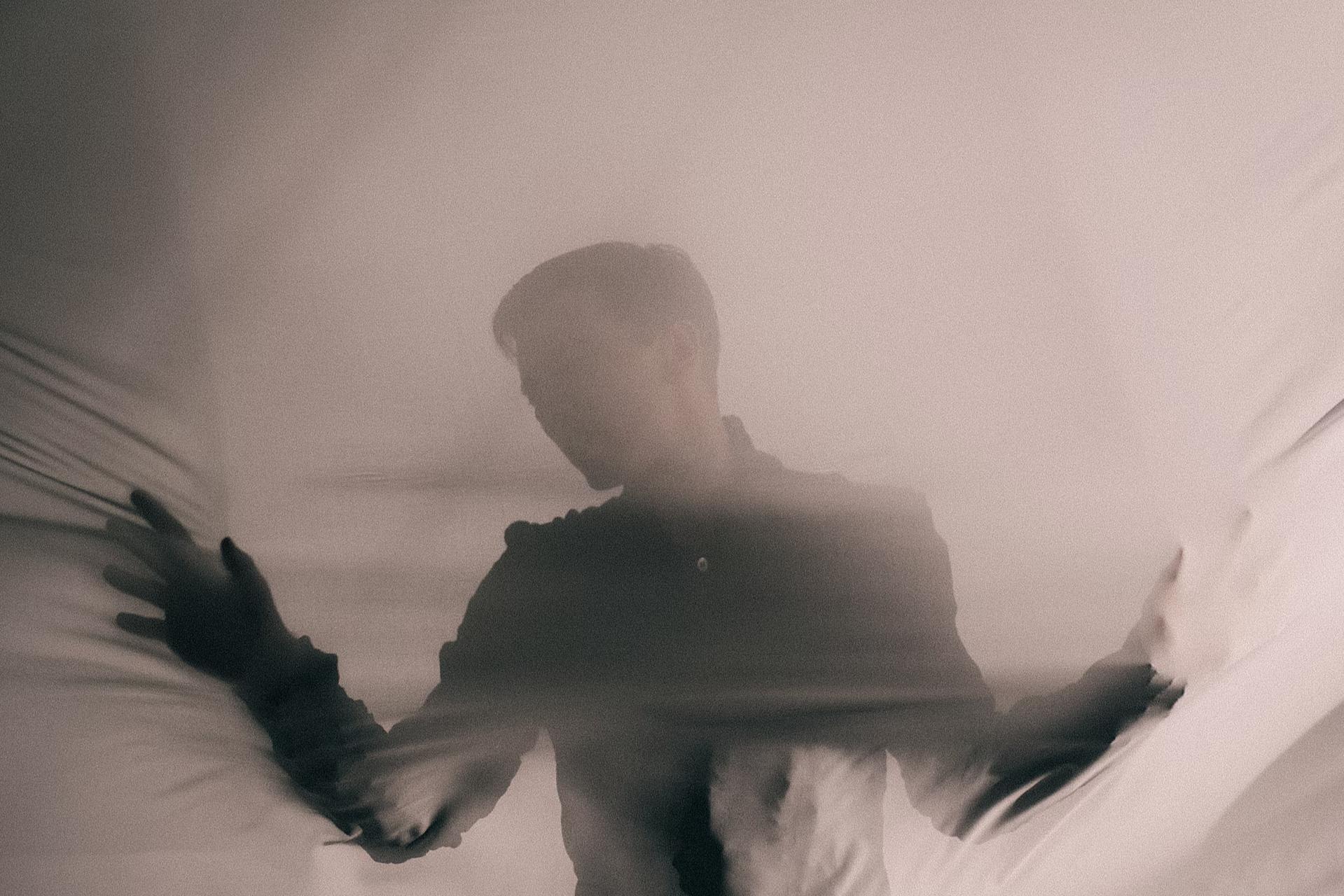 man covered with sheet