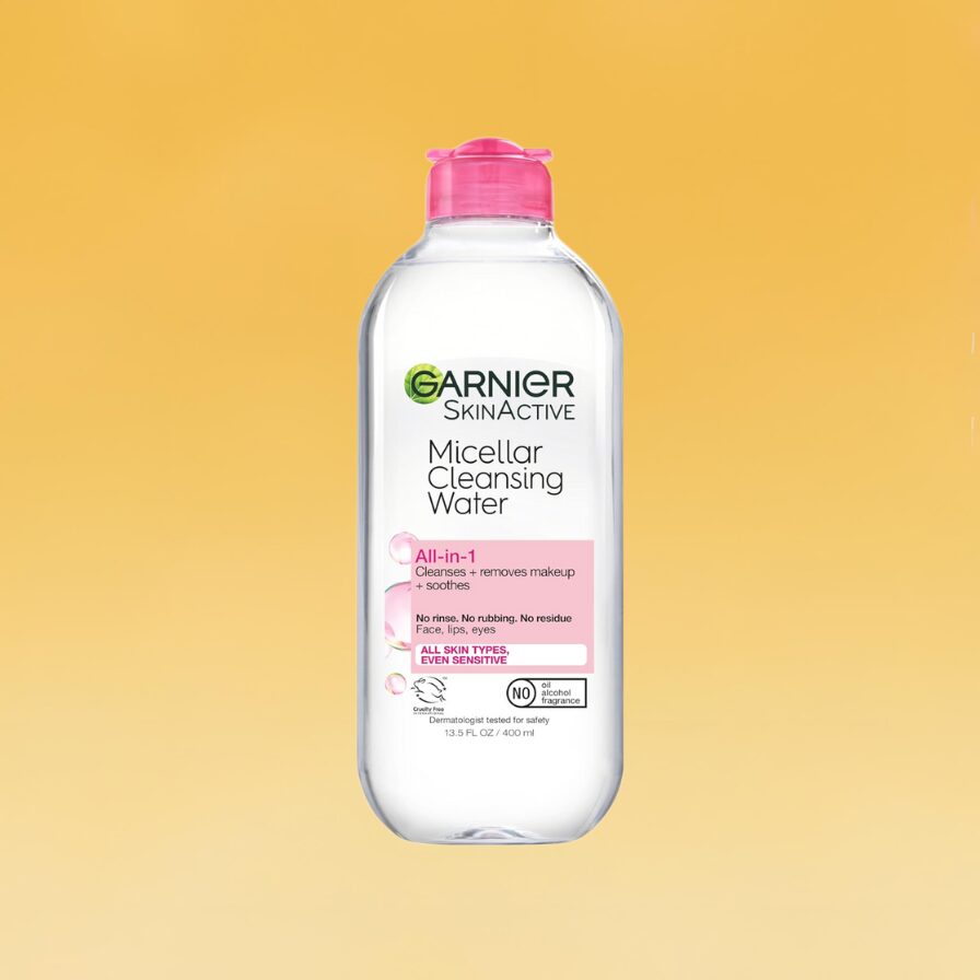 A clear bottle of Garnier SkinActive Micellar Cleansing Water sits against the yellow Body+Mind background.