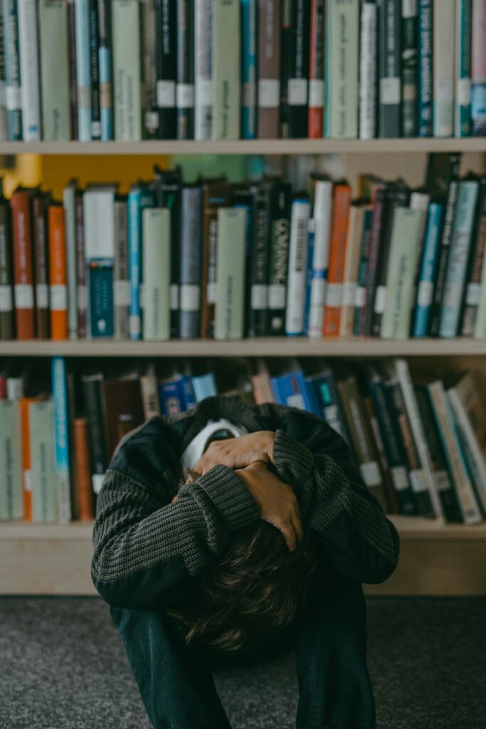 Boy Sitting in a Library