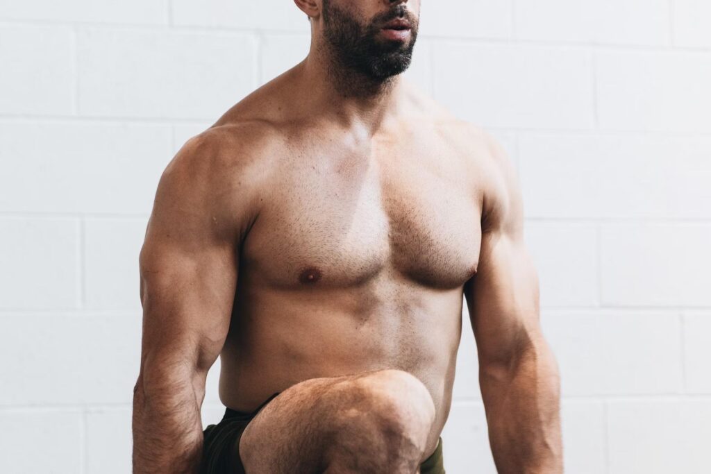 man exercising topless with black shorts