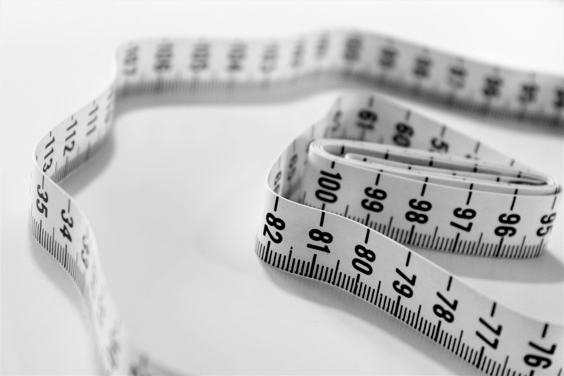 A measuring tape on a plain white background