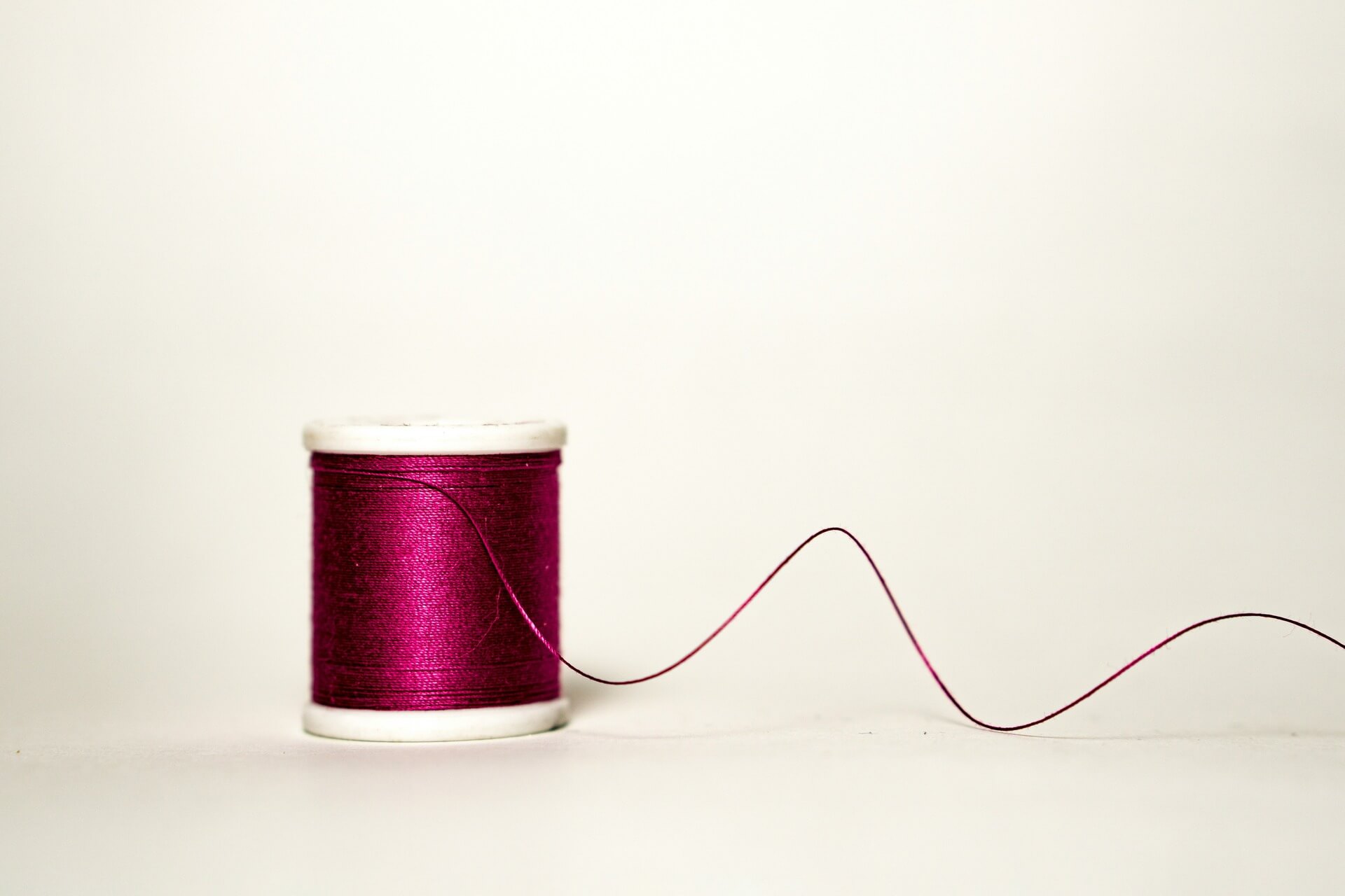 A thread of maroon cotton