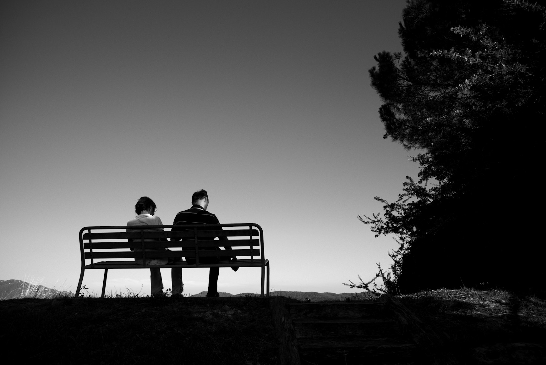 two people on a bench