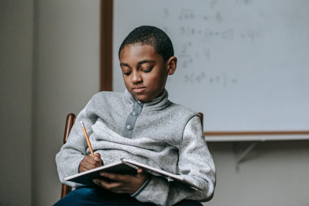kid doing task in copybook