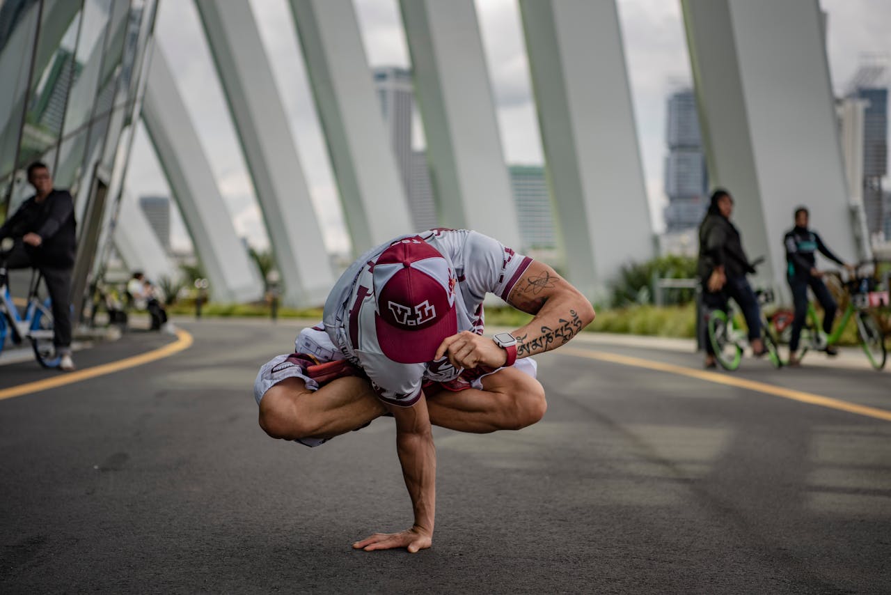 Person Practicing Yoga Pose Outdoors on Urban Street