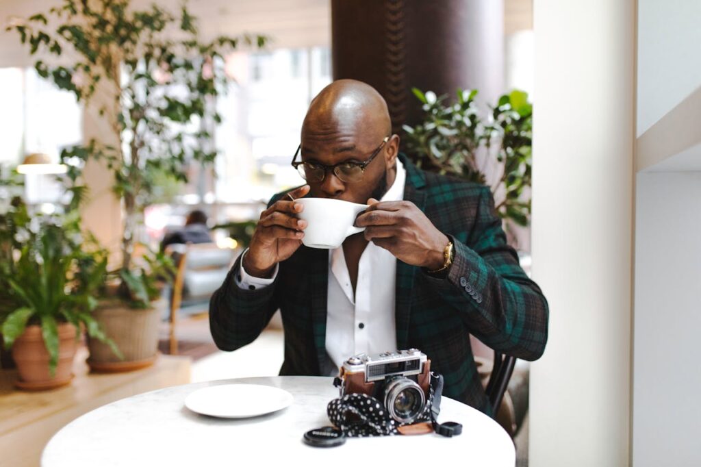 Man Sipping from White Ceramic Mug