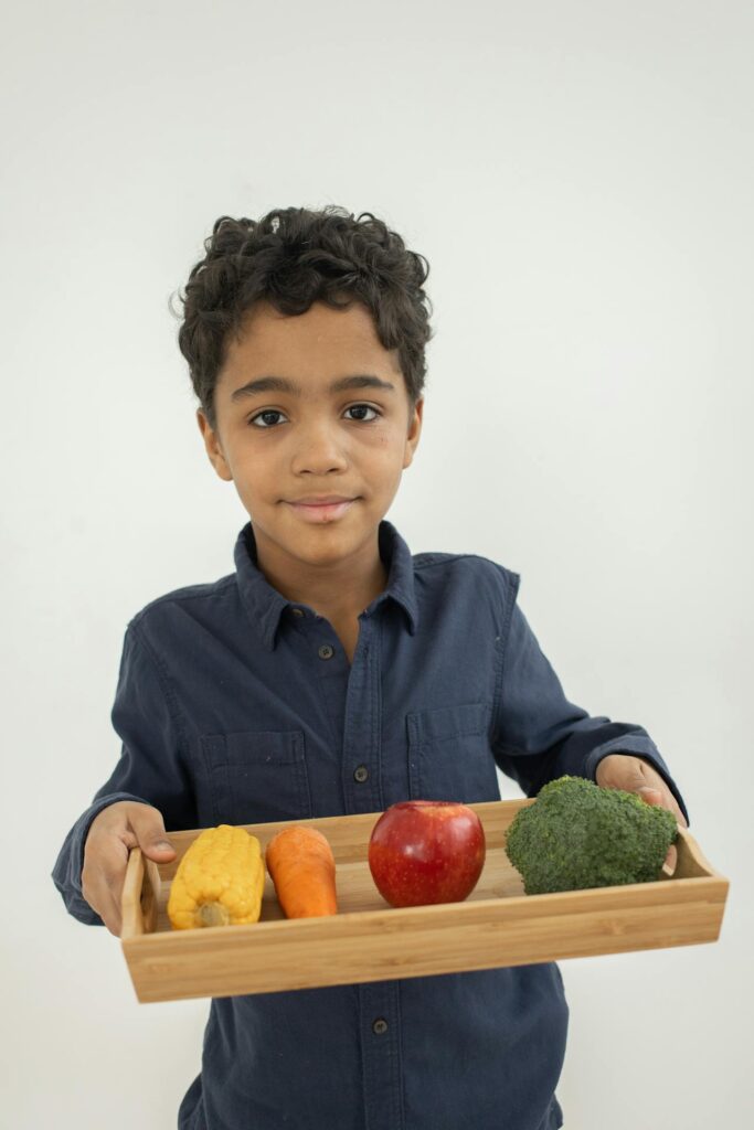 child with colorful healthy vegetables