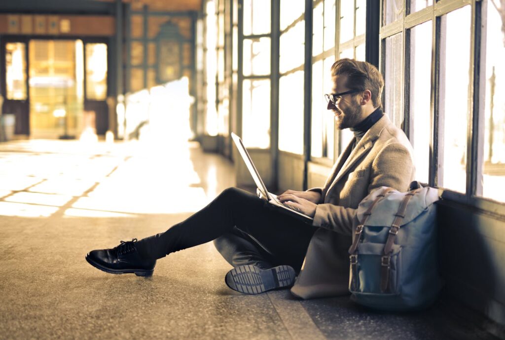 man speaking to a counselor on a laptop