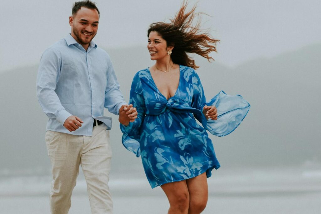 man and woman in blue running together and smiling