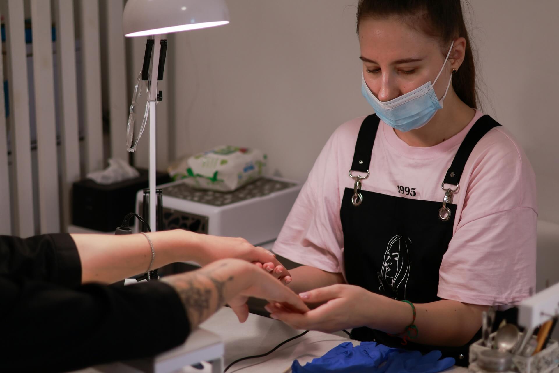 A woman performing a manicure