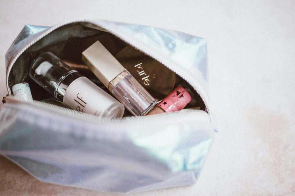 a makeup purse with glossy lipstick