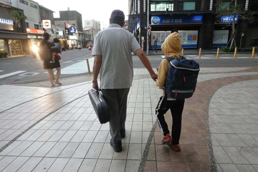 Man and child walk in the city