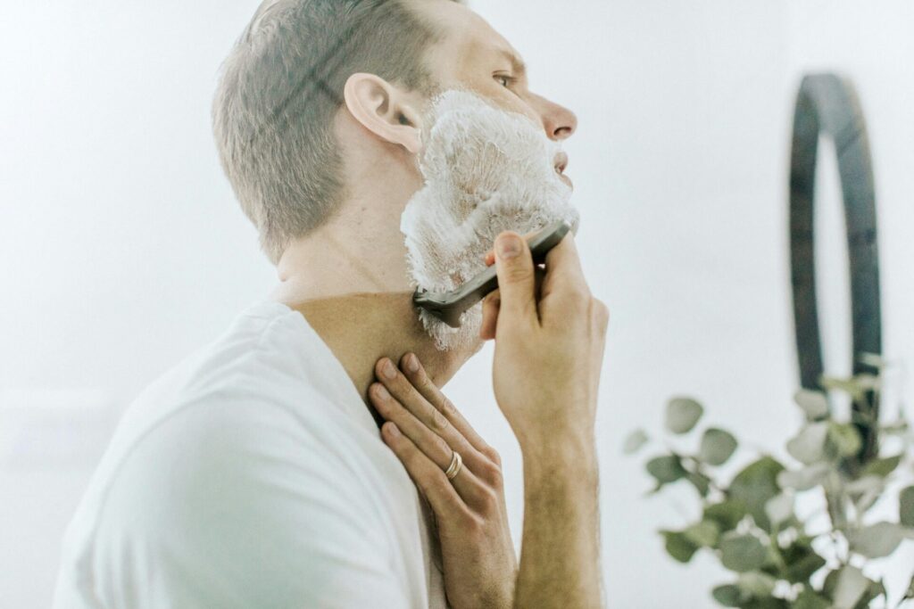 Man shaving beard with shaving cream