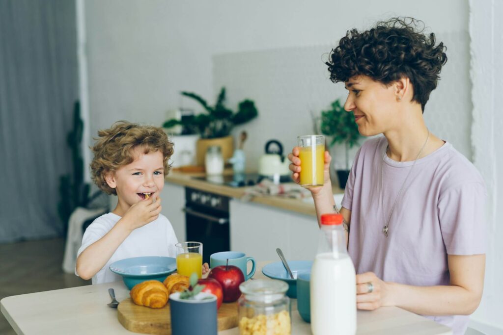 Parent eating breakfast with their child