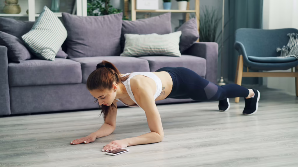 Person doing a plank with phone on the ground